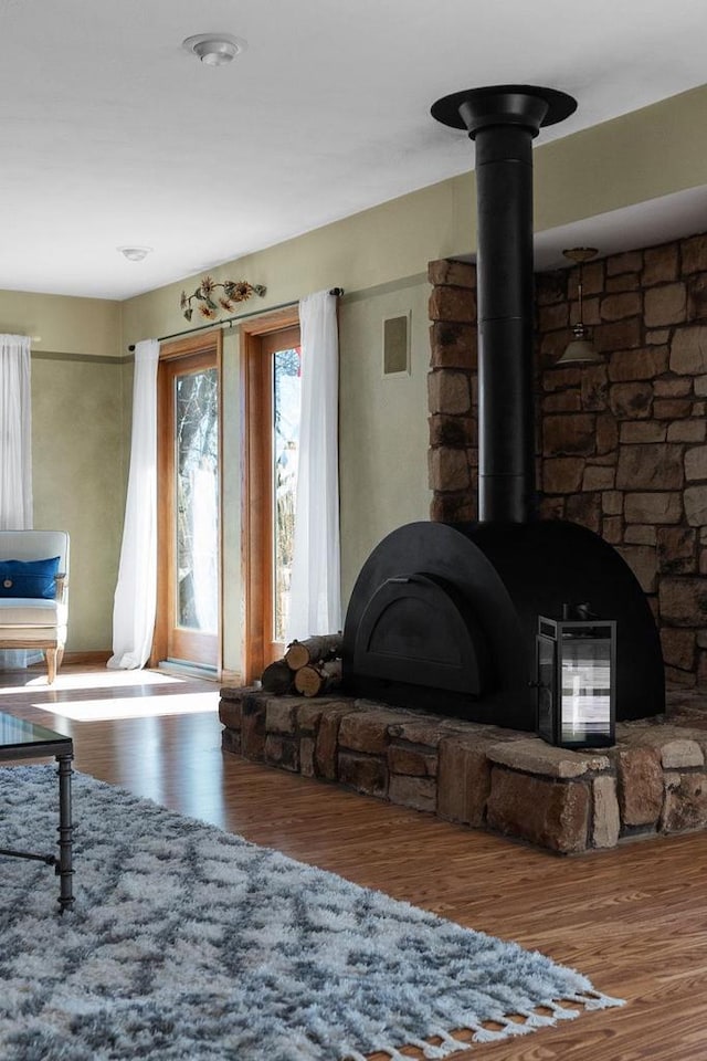 2022 27th St, Monroe, WI 53566 - living room with a wood stove, wood finished floors, and visible vents