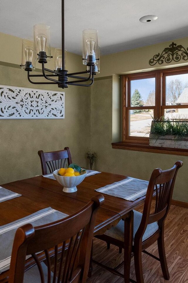 2022 27th St, Monroe, WI 53566 - dining room with wood finished floors and a chandelier