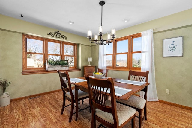 2022 27th St, Monroe, WI 53566 - dining room with an inviting chandelier, baseboards, and light wood finished floors