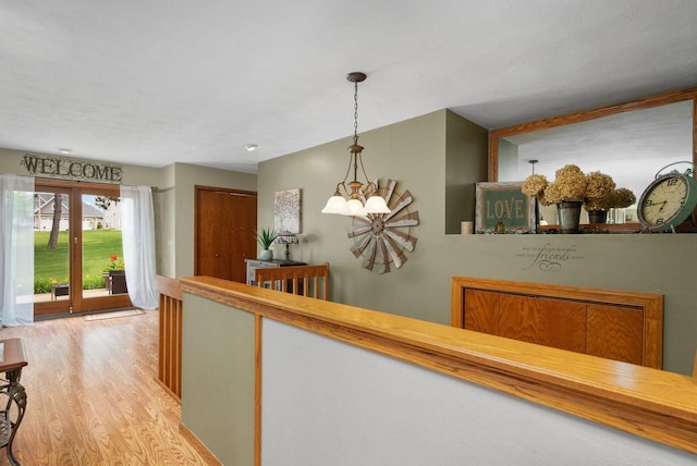 2022 27th St, Monroe, WI 53566 - corridor with light wood-style floors and a chandelier