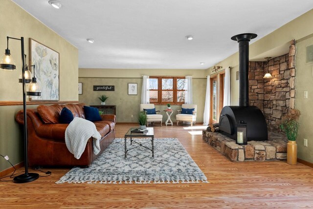 2022 27th St, Monroe, WI 53566 - living room featuring a wood stove, baseboards, and wood finished floors