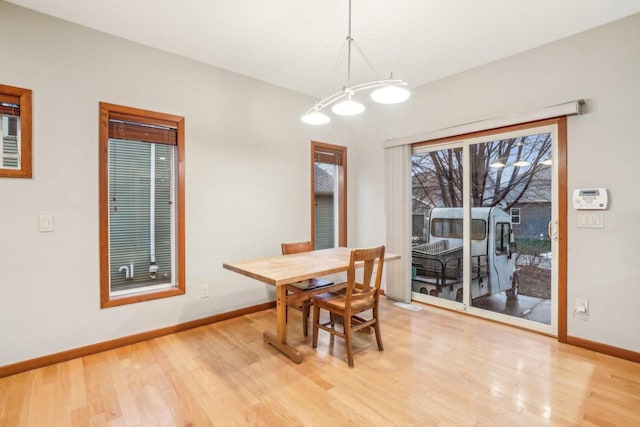 dining space featuring a notable chandelier and light hardwood / wood-style flooring