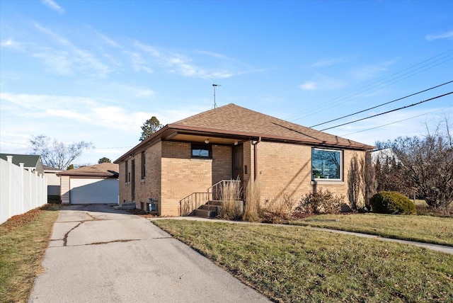 view of front of property with an outbuilding, a garage, and a front yard