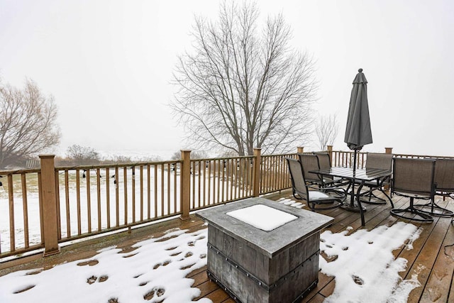 snow covered deck with an outdoor fire pit