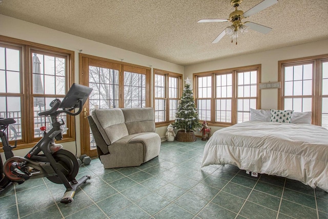 bedroom with a textured ceiling and ceiling fan