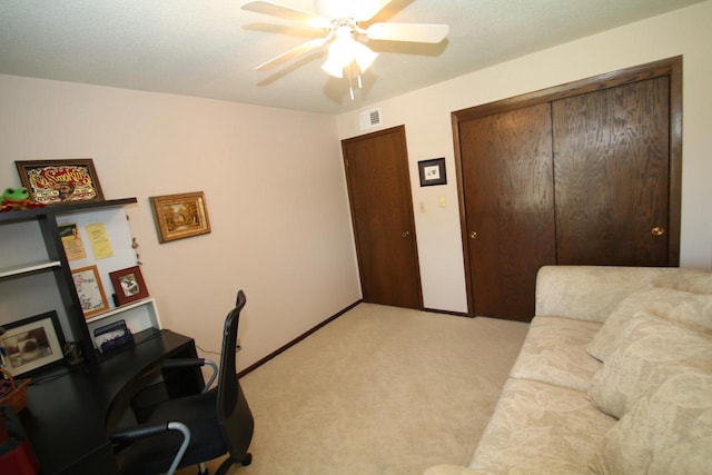 carpeted office featuring ceiling fan