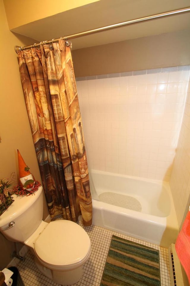 bathroom featuring tile patterned floors, toilet, and shower / tub combo with curtain