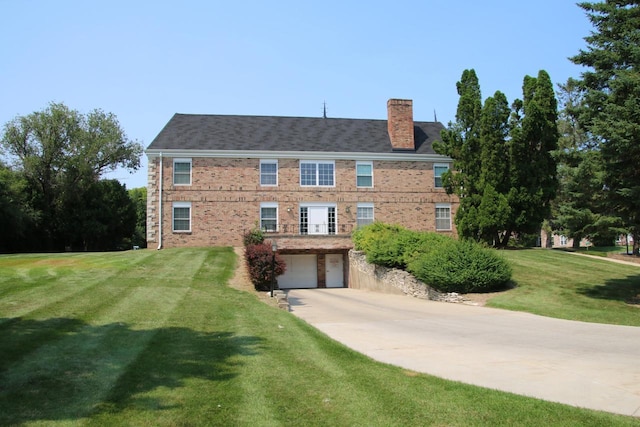 view of front of property with a garage and a front lawn