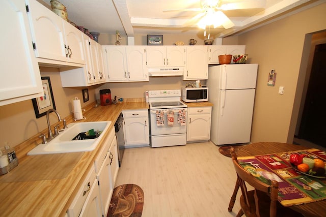 kitchen with white appliances, sink, light hardwood / wood-style flooring, ceiling fan, and white cabinetry