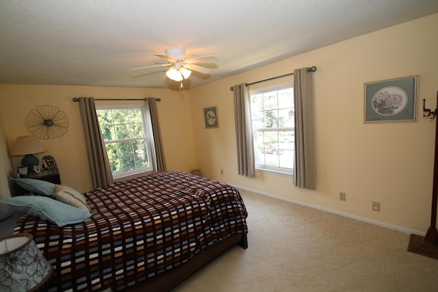 bedroom with carpet flooring, multiple windows, ceiling fan, and a textured ceiling