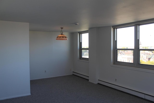 carpeted empty room featuring a baseboard radiator