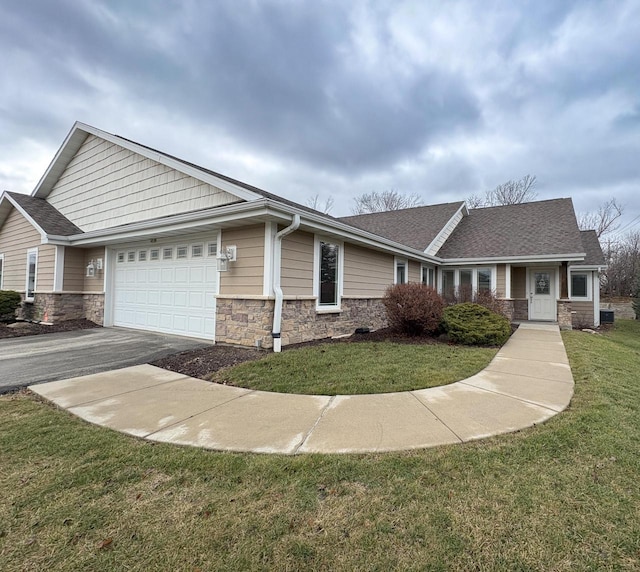 single story home with a garage and a front lawn