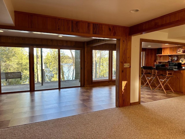 N7859 Lakeside Park Rd, Elkhart Lake, WI 53020 - unfurnished living room with light colored carpet and wood walls