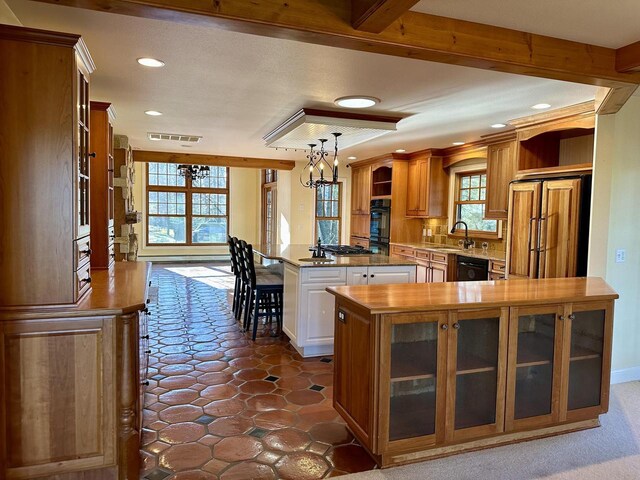 N7859 Lakeside Park Rd, Elkhart Lake, WI 53020 - kitchen featuring decorative light fixtures, dishwasher, a kitchen bar, a center island, and paneled built in fridge