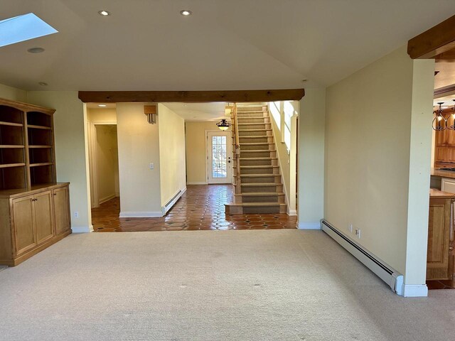 N7859 Lakeside Park Rd, Elkhart Lake, WI 53020 - unfurnished living room featuring vaulted ceiling with skylight, a baseboard heating unit, and light carpet