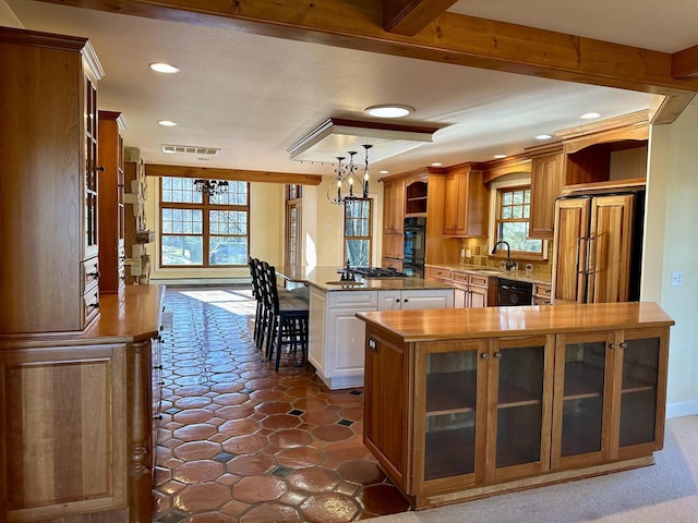 N7859 Lakeside Park Rd, Elkhart Lake, WI 53020 - kitchen with pendant lighting, dishwasher, a kitchen bar, a center island, and paneled refrigerator