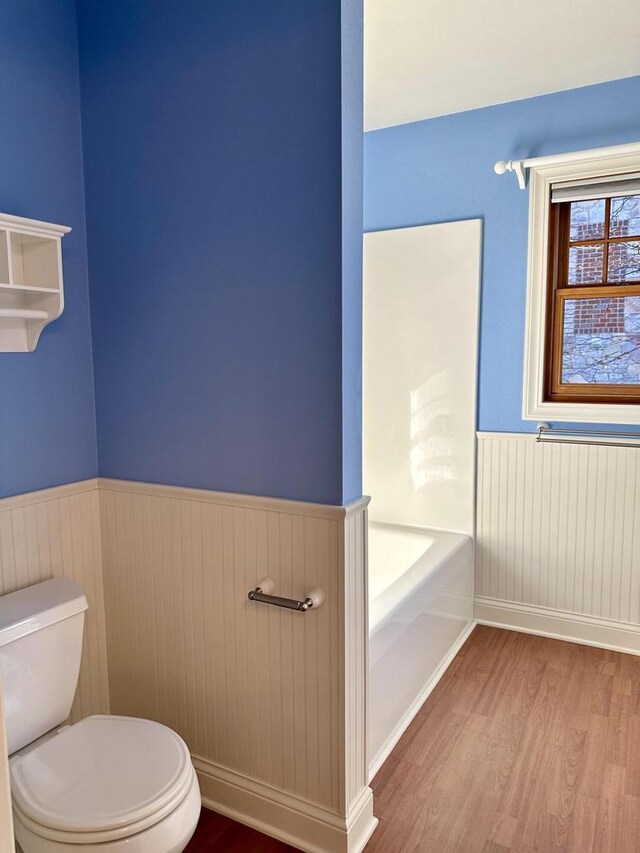 N7859 Lakeside Park Rd, Elkhart Lake, WI 53020 - bathroom featuring a tub, hardwood / wood-style floors, and toilet
