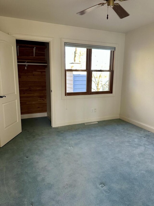 N7859 Lakeside Park Rd, Elkhart Lake, WI 53020 - unfurnished bedroom featuring carpet flooring, ceiling fan, and a closet
