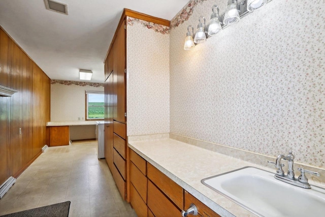 bathroom with wooden walls and sink