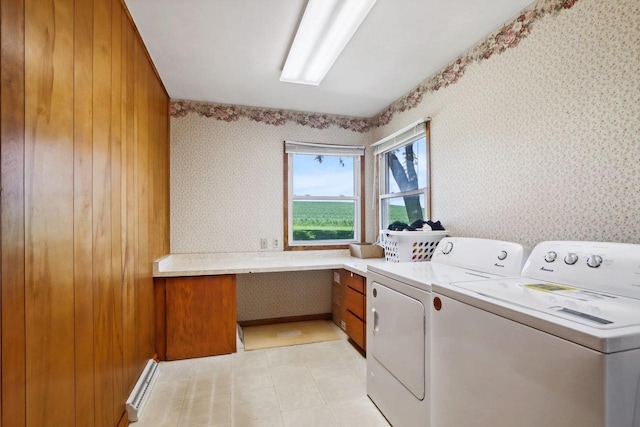 clothes washing area with washing machine and dryer and baseboard heating