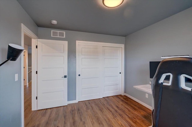 home office with wood-type flooring