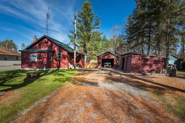 view of front of house with an outdoor structure and a front yard