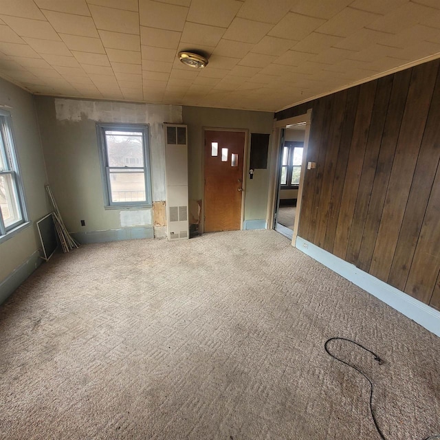 interior space featuring plenty of natural light and wood walls