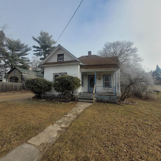 bungalow-style house featuring a porch and a front lawn