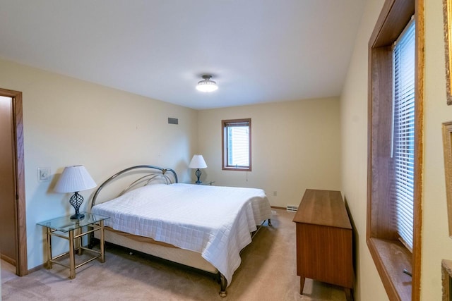 bedroom featuring light colored carpet and a baseboard radiator