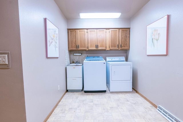 washroom featuring cabinets, sink, and washer and dryer