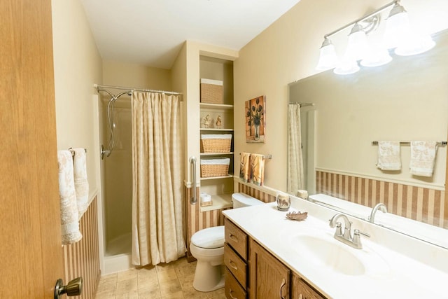 bathroom featuring toilet, vanity, and a shower with shower curtain