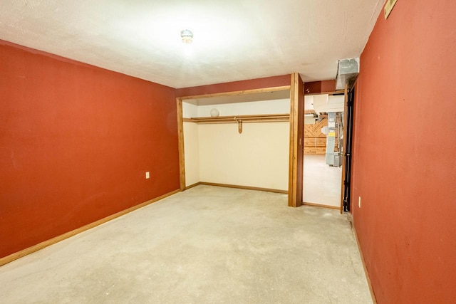 unfurnished bedroom featuring light carpet and a closet