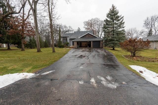 view of front of home with a front yard and a garage