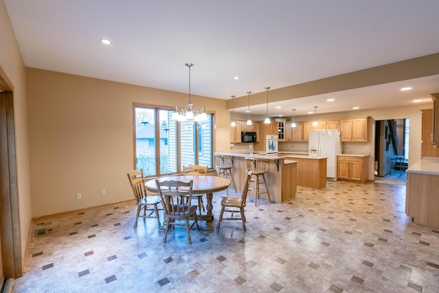 dining space with an inviting chandelier