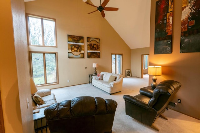 living room with carpet, ceiling fan, high vaulted ceiling, and a healthy amount of sunlight