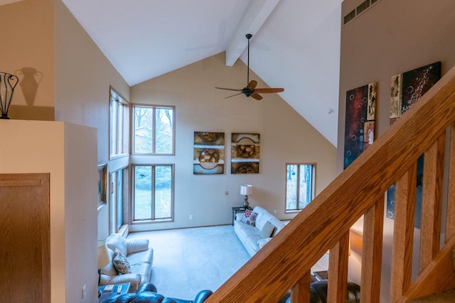 living room with ceiling fan, beamed ceiling, and high vaulted ceiling