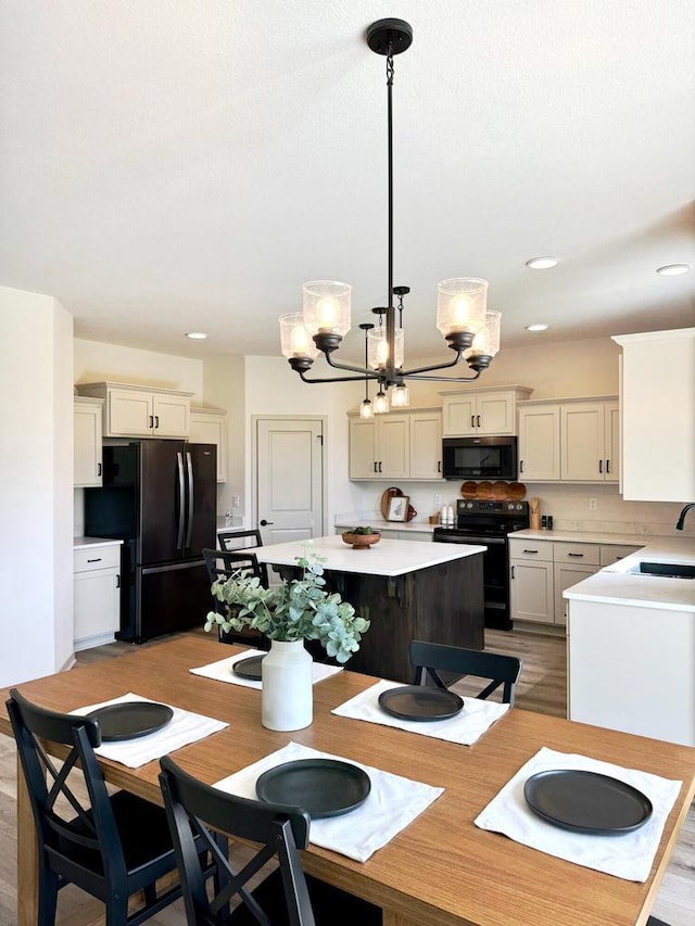 dining area featuring a chandelier, light hardwood / wood-style flooring, and sink