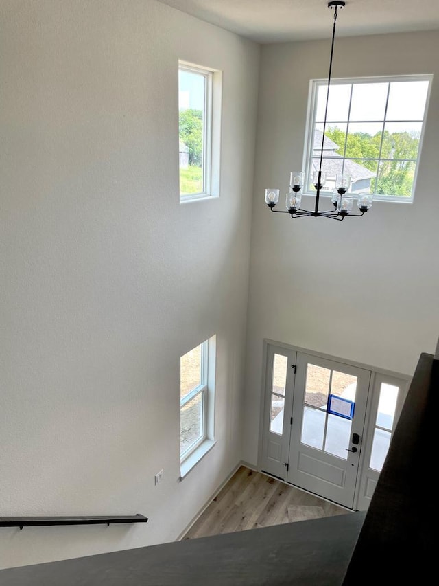 entrance foyer featuring a notable chandelier and light wood-type flooring