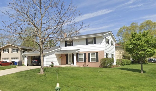 view of front of home with a front yard and a garage