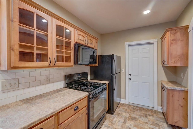 kitchen featuring tasteful backsplash, light brown cabinetry, and black appliances