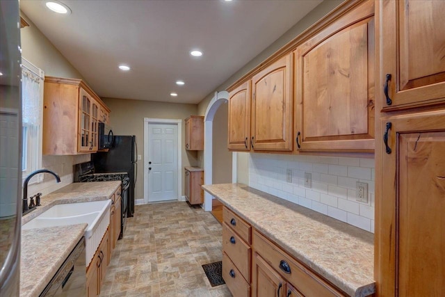 kitchen with backsplash and black appliances