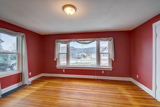 spare room with hardwood / wood-style floors