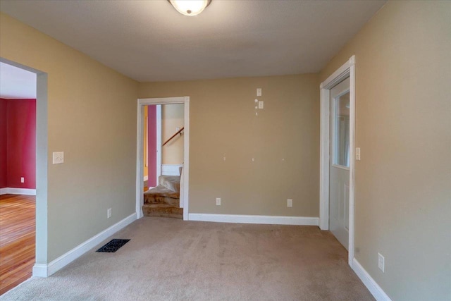 empty room featuring light colored carpet