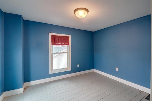 empty room with hardwood / wood-style flooring