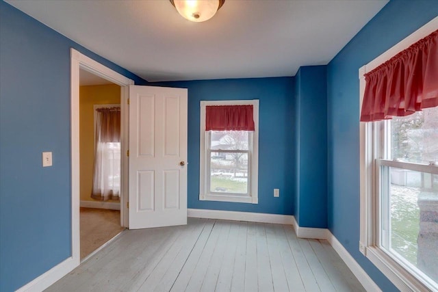 unfurnished room featuring light wood-type flooring