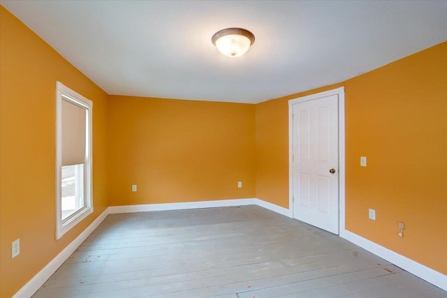 unfurnished room with wood-type flooring