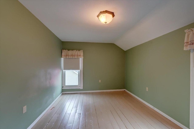 interior space featuring vaulted ceiling and light hardwood / wood-style floors