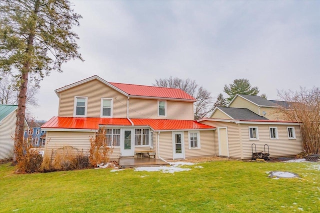 back of property featuring a patio and a lawn