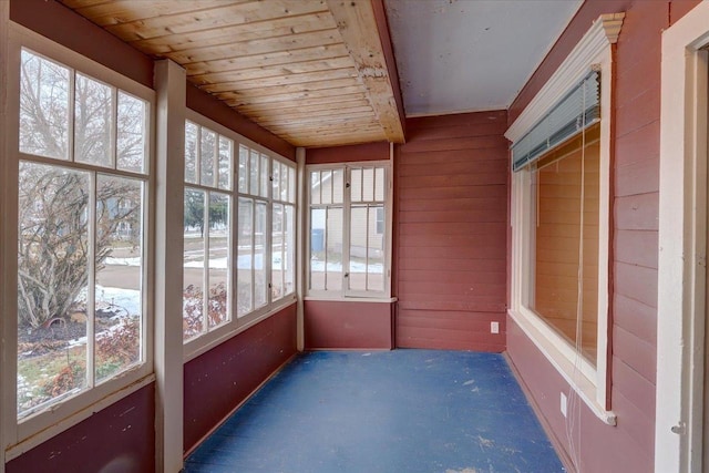 unfurnished sunroom with wood ceiling