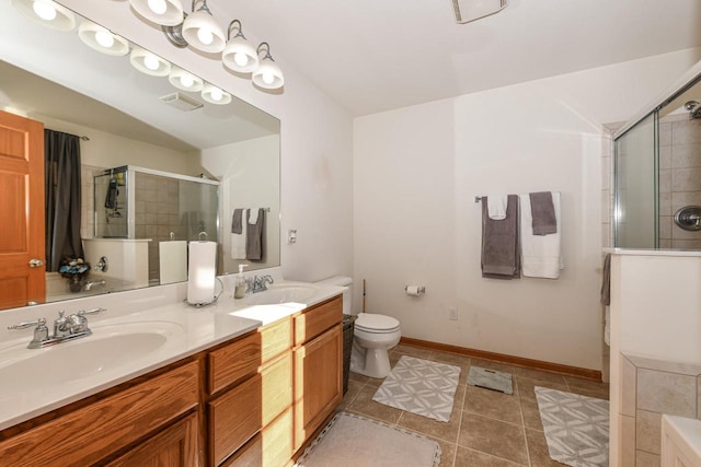 bathroom featuring vanity, toilet, and a shower with door